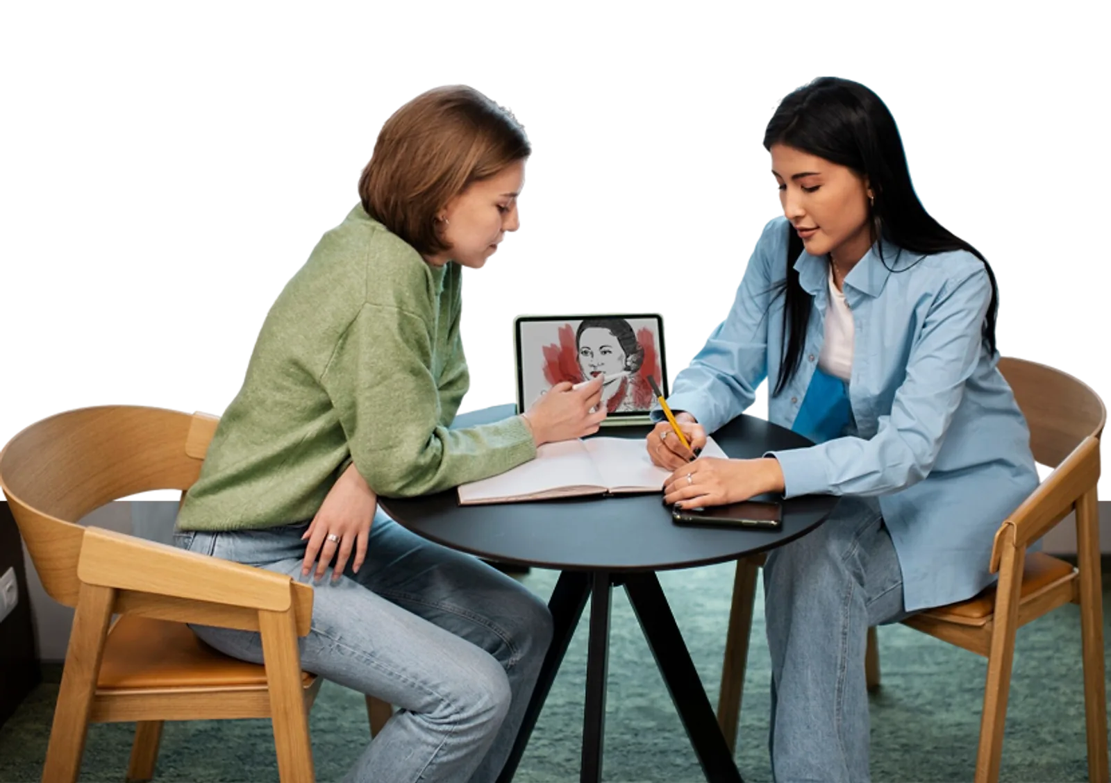 Two women discuss artwork on a tablet during an LLND skills development session.