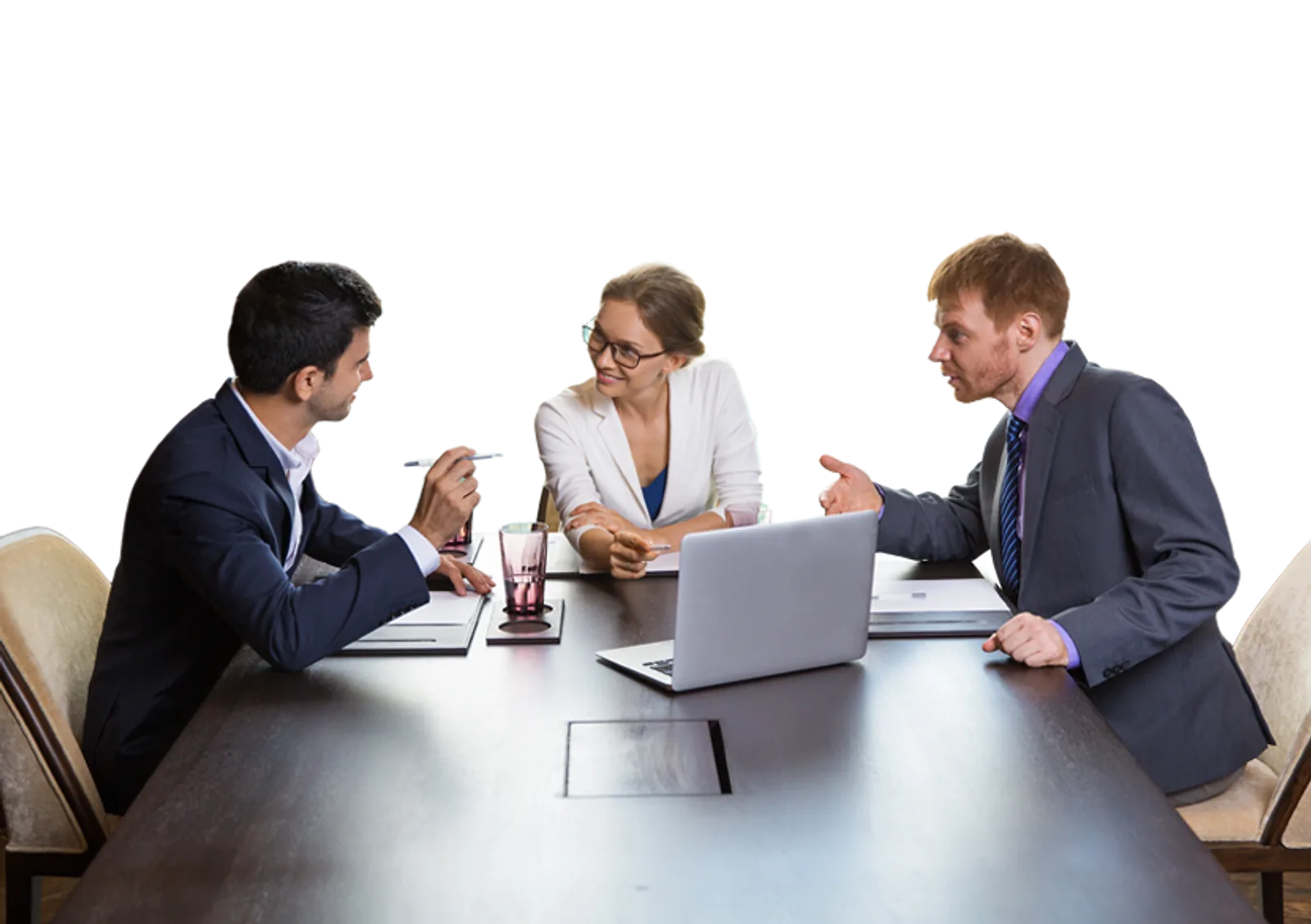 A team of business professionals collaborate around a conference table, discussing ideas and using a laptop for skills.