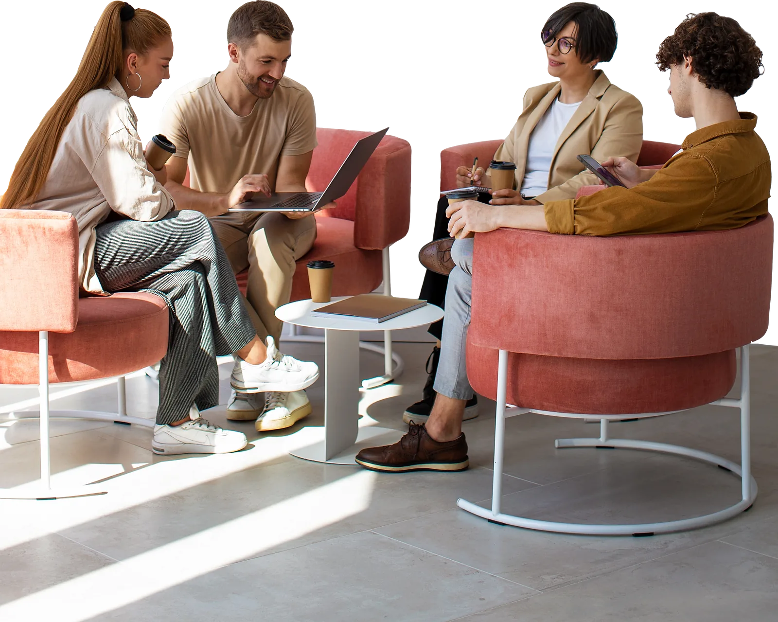 A business team collaborates around laptops, demonstrating employability skills in a casual office setting.