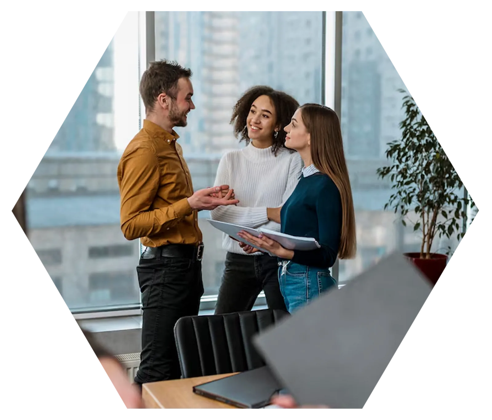 Team Collaboration | CAQA LLND A business team collaborates on documents in a modern office, supporting resource development.