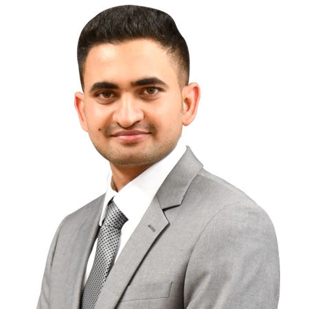 A man in a suit and tie looks directly at the camera, representing our team at CAQA LLND.