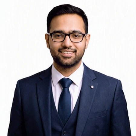 Gourav Sharma smiles for a portrait as part of the CAQA LLND team.