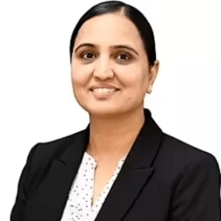 Mandeep Chahil is a professional smiling in business attire as part of the CAQA LLND team.