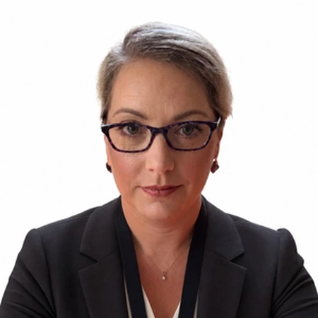 A professional portrait of Nadia Spain, a member of the CAQA LLND team.