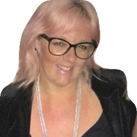 Nicole Talarico smiles wearing glasses and a lanyard, part of the CAQA LLND team.