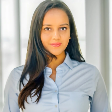 Pooja Tejashbhai Siddhapura, a professional headshot wearing a light blue shirt.