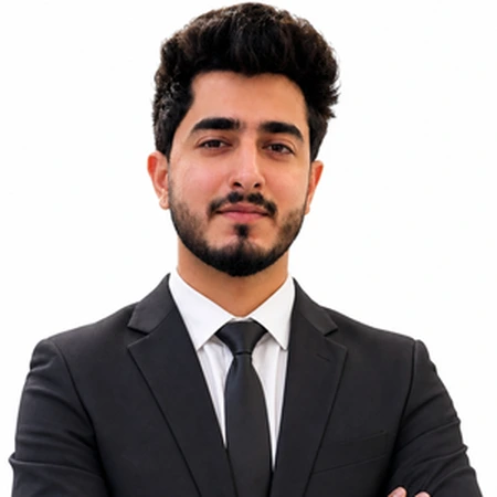 A young man in a suit poses for a professional headshot of Rishabh Arora.