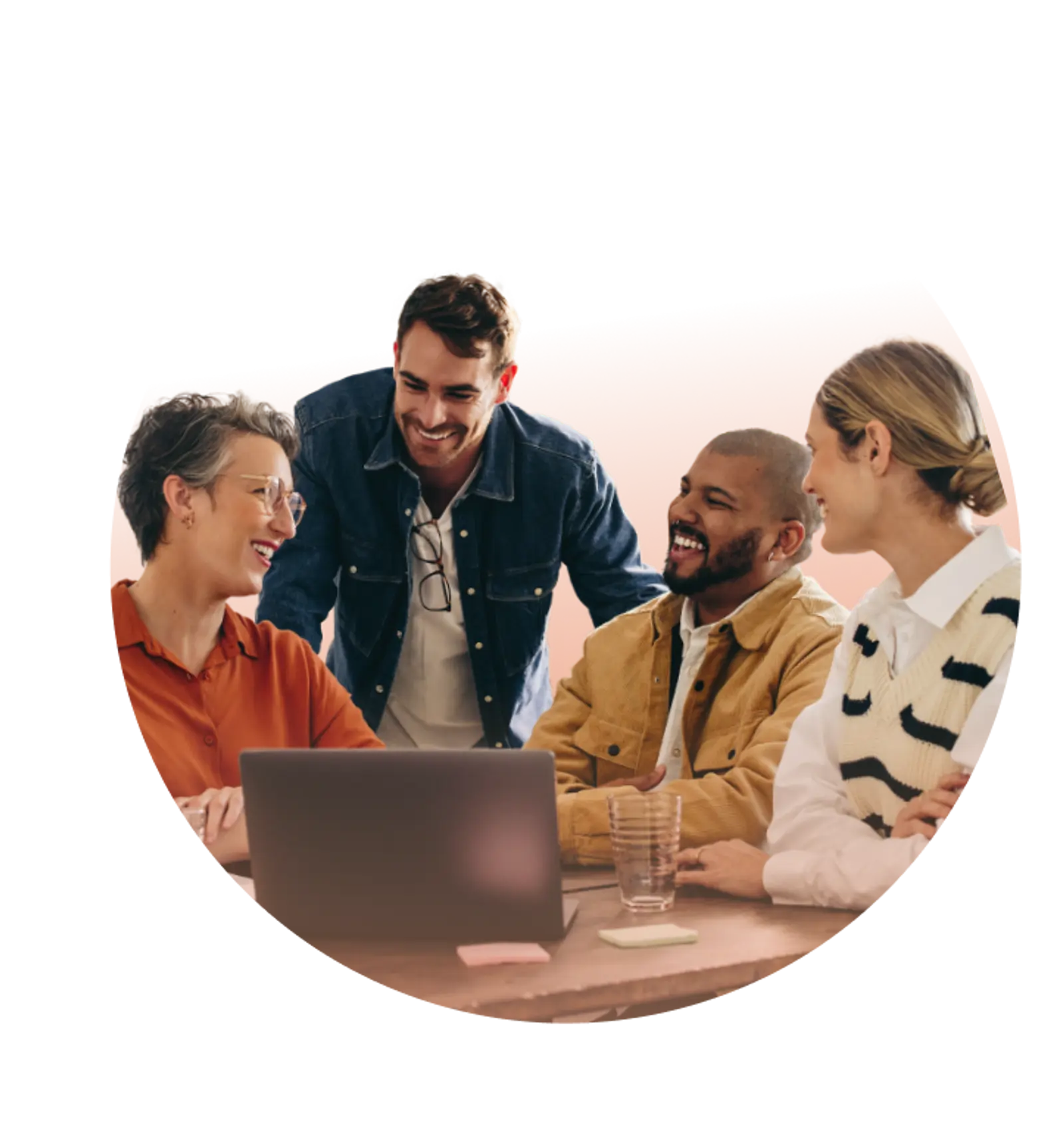 Teamwork | CAQA LLND Four colleagues collaborate around a laptop during a cheerful meeting, demonstrating how CAQA LLND supports RTOs with skills.