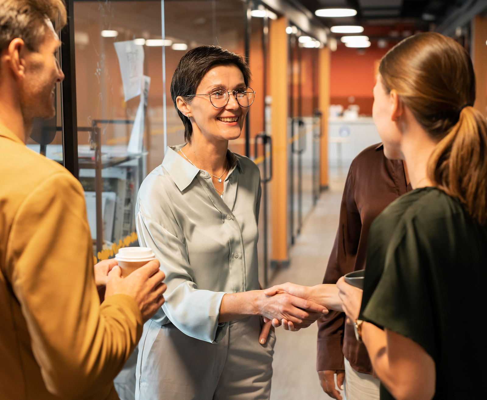 Two professionals shake hands, representing a successful training partnership.